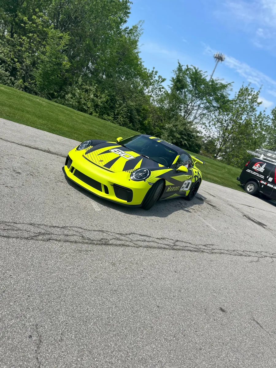 Porsche 911 GT3 after an acid green color change wrap
