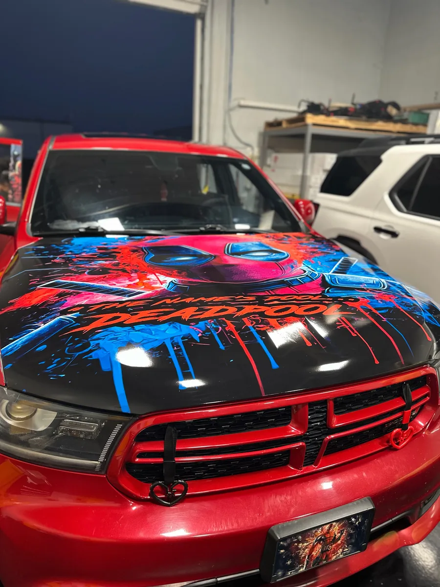 Red Dodge Durango with a drip hood graphic