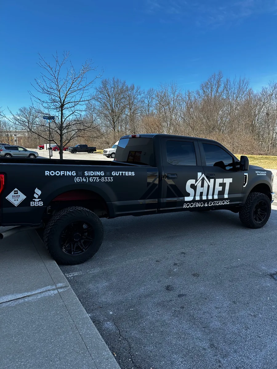 Roofing company Ford F-250 in a black wrap with lettering