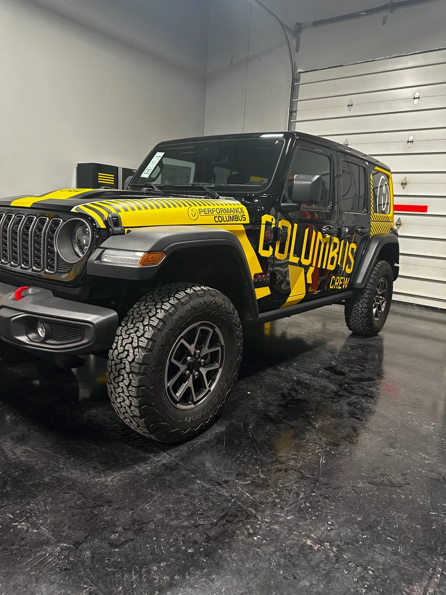 Jeep Wrangler after yellow and black company graphics