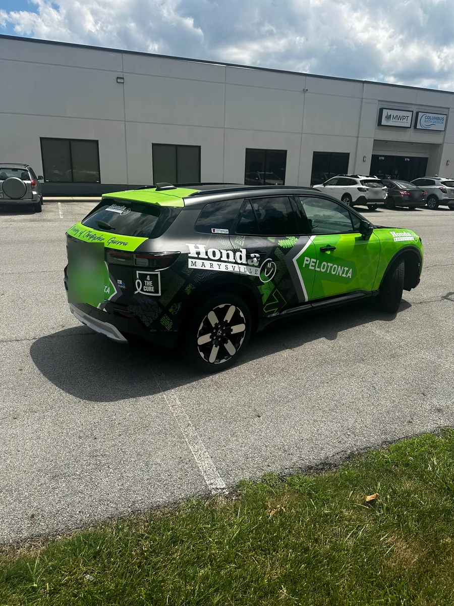 Honda Prologue with green, black, and white branded graphics