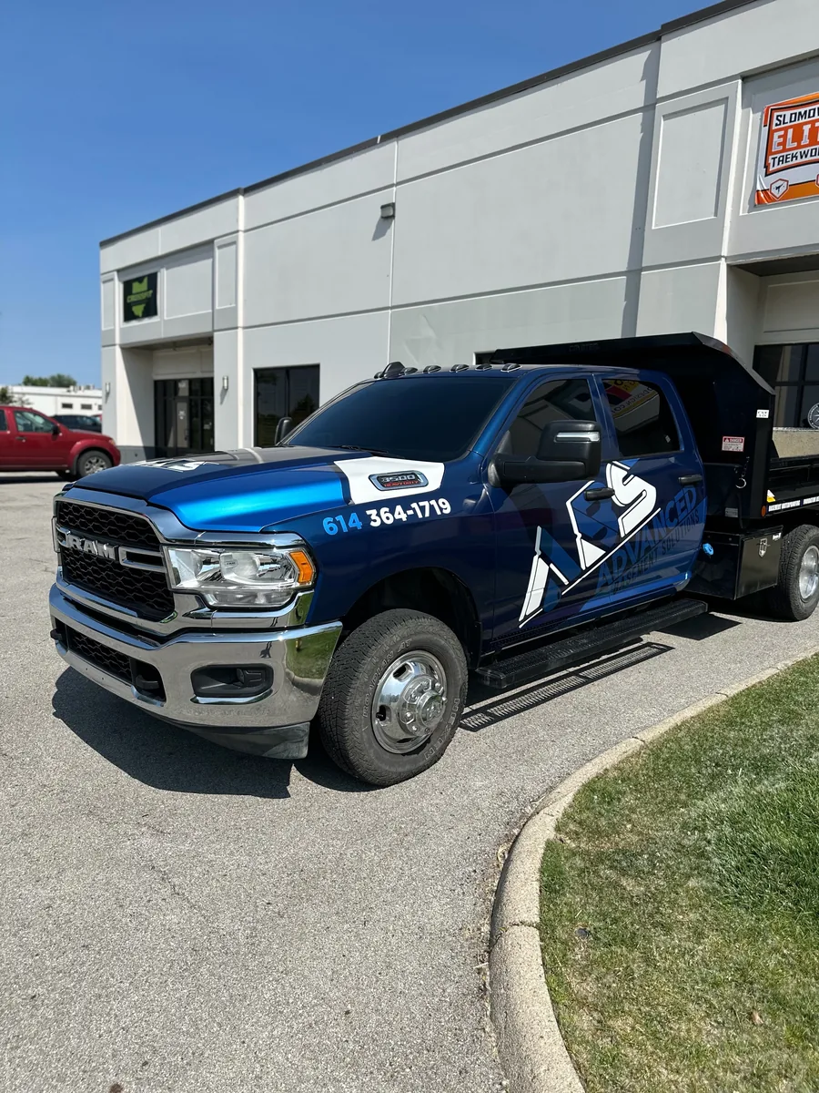 Ram 3500 pickup with blue branded fleet graphics