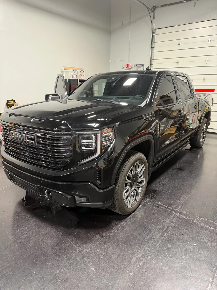 Black GMC Sierra pickup before its printed wrap