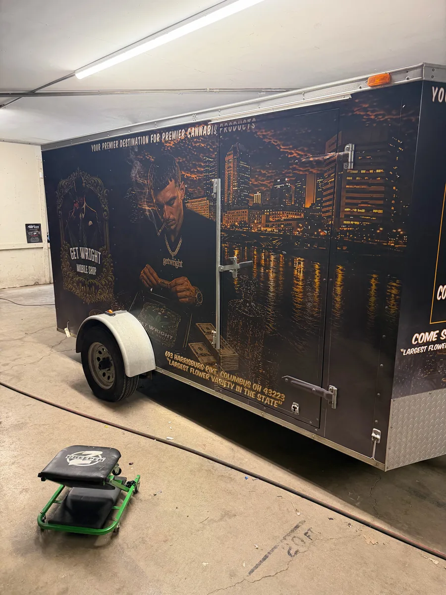 Cargo trailer wrapped as a mobile barbershop