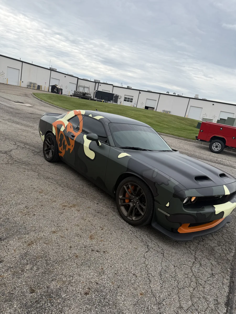 Black Dodge Challenger with a fender graphic