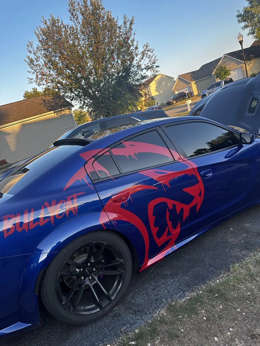 Blue widebody Dodge Charger with a red graphic