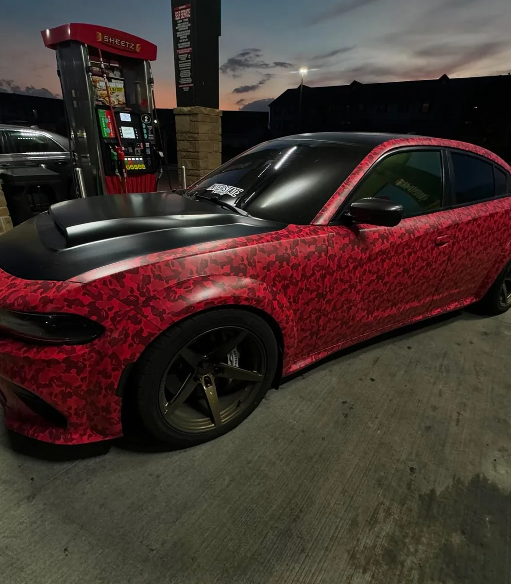 Dodge Charger in a red custom print wrap at night