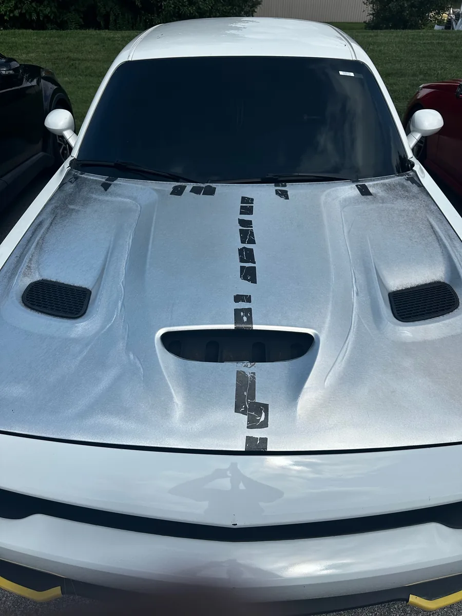 Dodge Challenger hood laid out for a stripe install