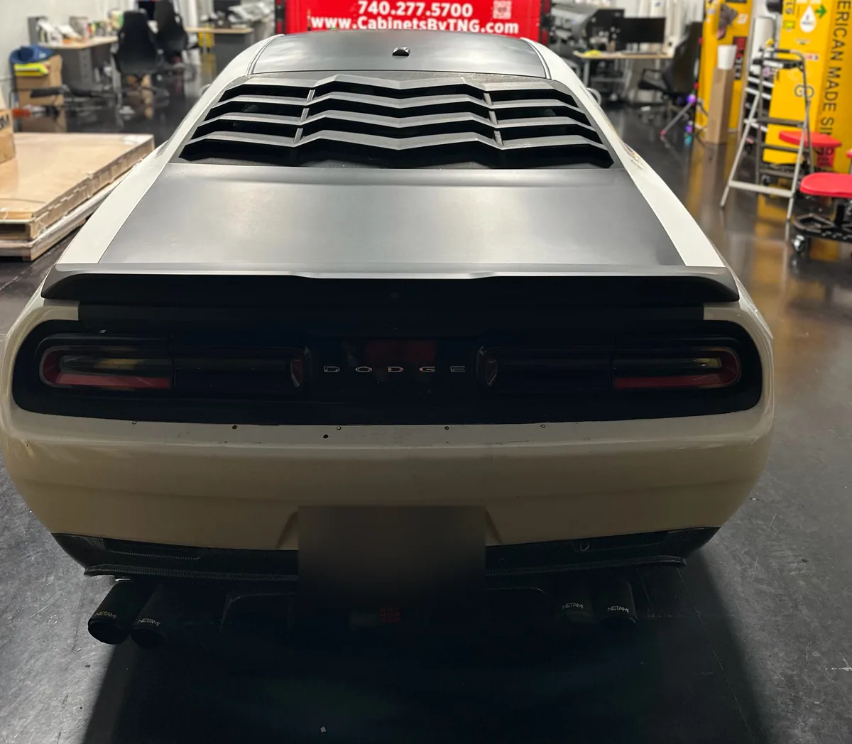 Four steps of a Dodge Challenger hood and stripe install
