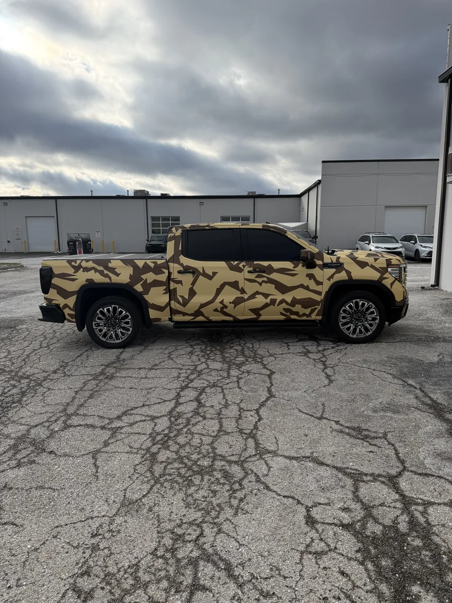 GMC Sierra pickup in a printed camo wrap