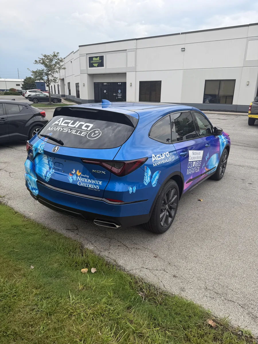 Acura SUV with blue and purple branded graphics