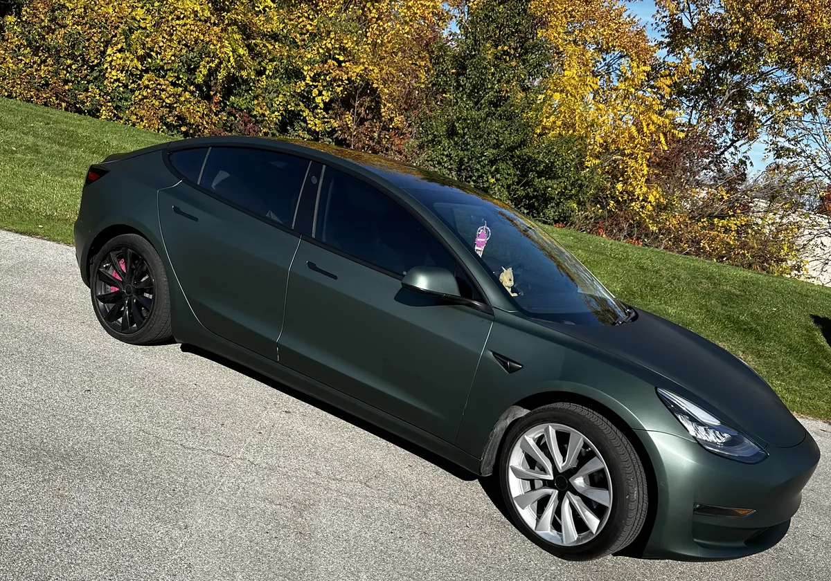 Tesla in a dark green color change wrap