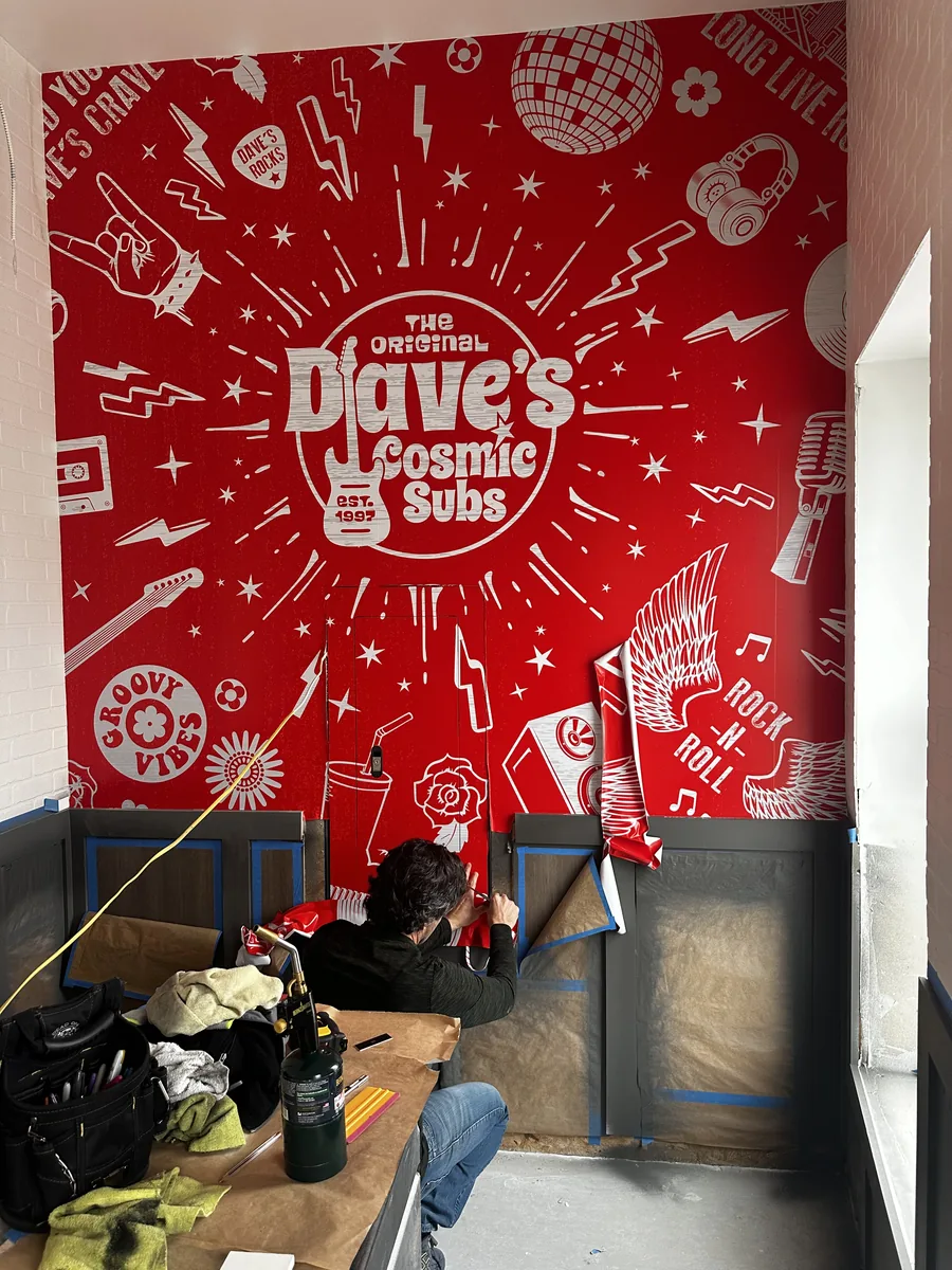 Red restaurant wall mural during install