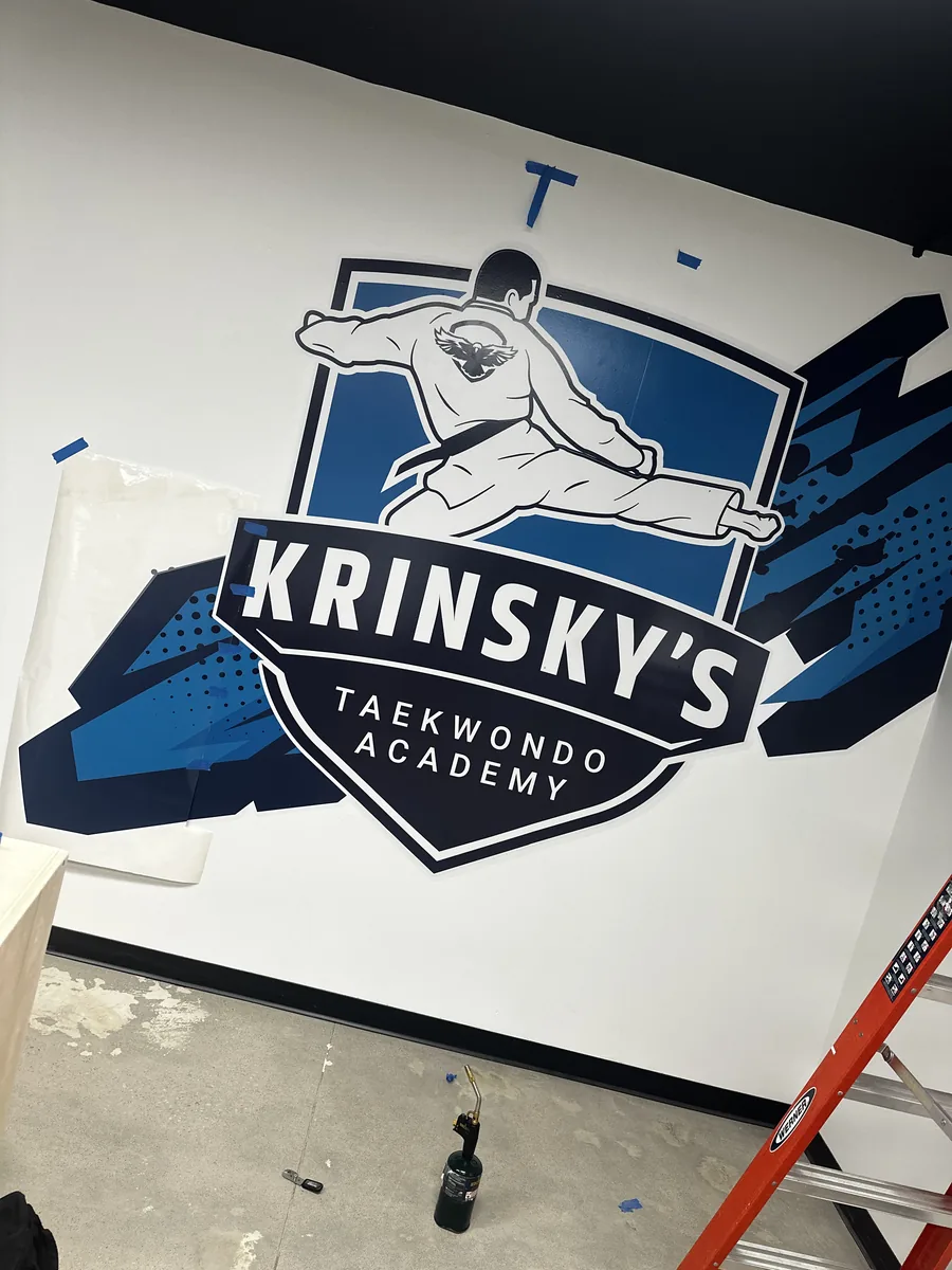 Taekwondo school logo wall graphic during install