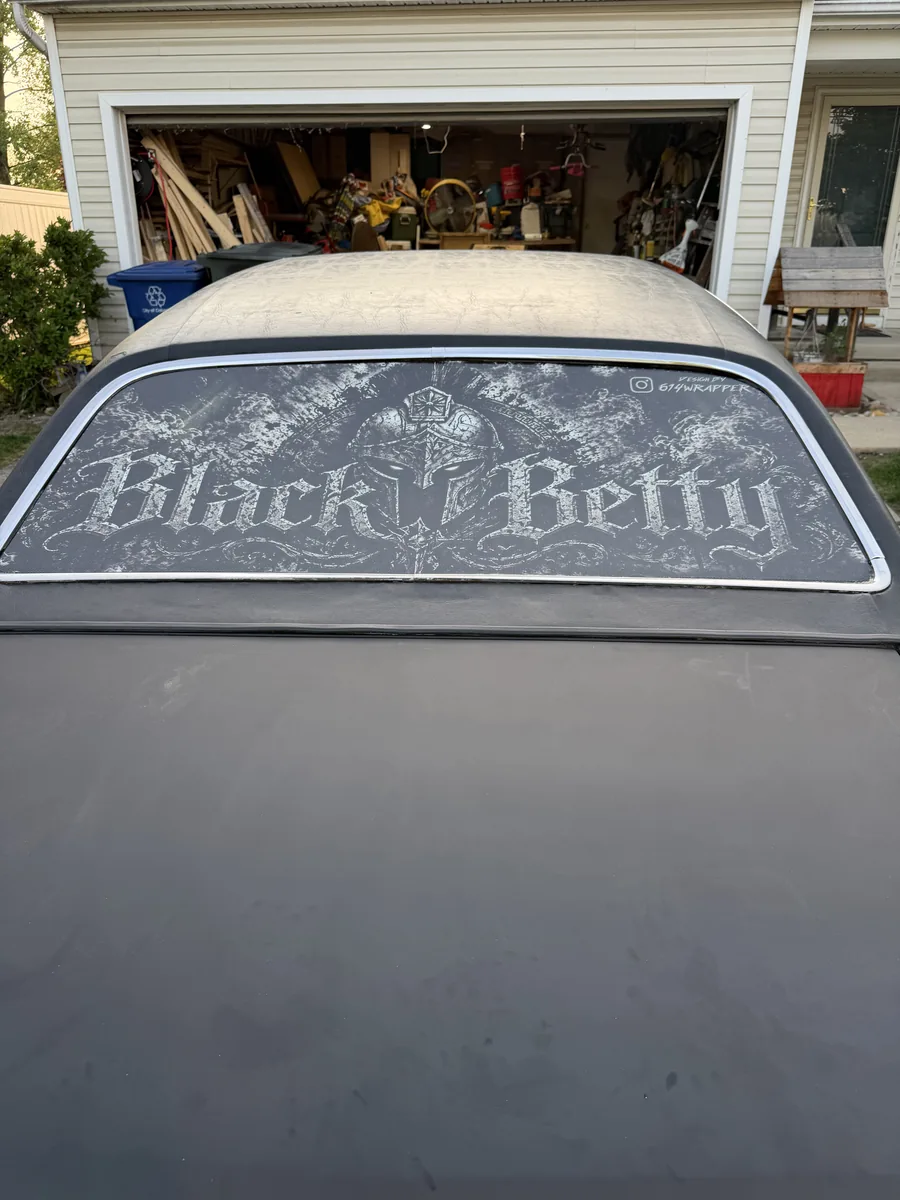 Custom rear glass graphic on a matte black car